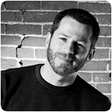 Black and white cropped headshot with me just a little off center and a big smile.